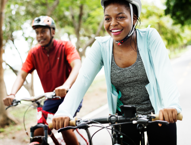 black female and black male riding bikes outdoors