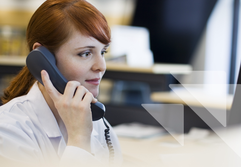 A young woman with red hair talks on the phone