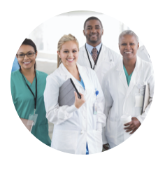 One healthcare professional in scrubs and three healthcare professionals in white coats standing together and smiling